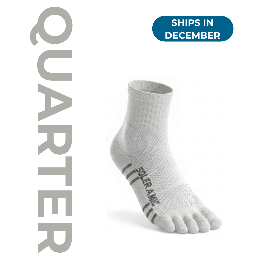 Soleramic Performance Quarter Sock in black and gray, made of breathable athletic material with reinforced heel and toe.